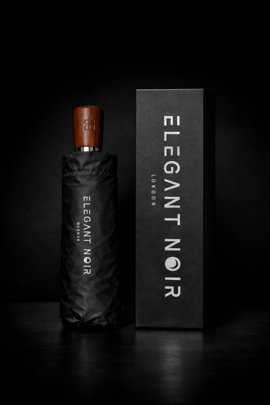 Black umbrella with wooden handle and 'Elegant Noir' branding on a dark background