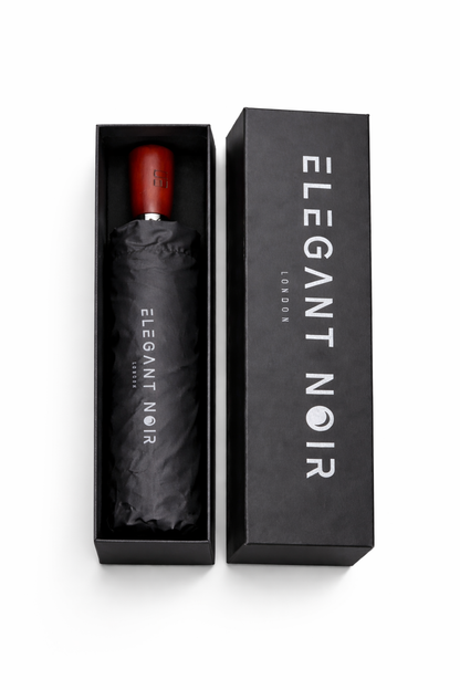 Black umbrella with wooden handle in an 'Elegant Noir' box on a white background