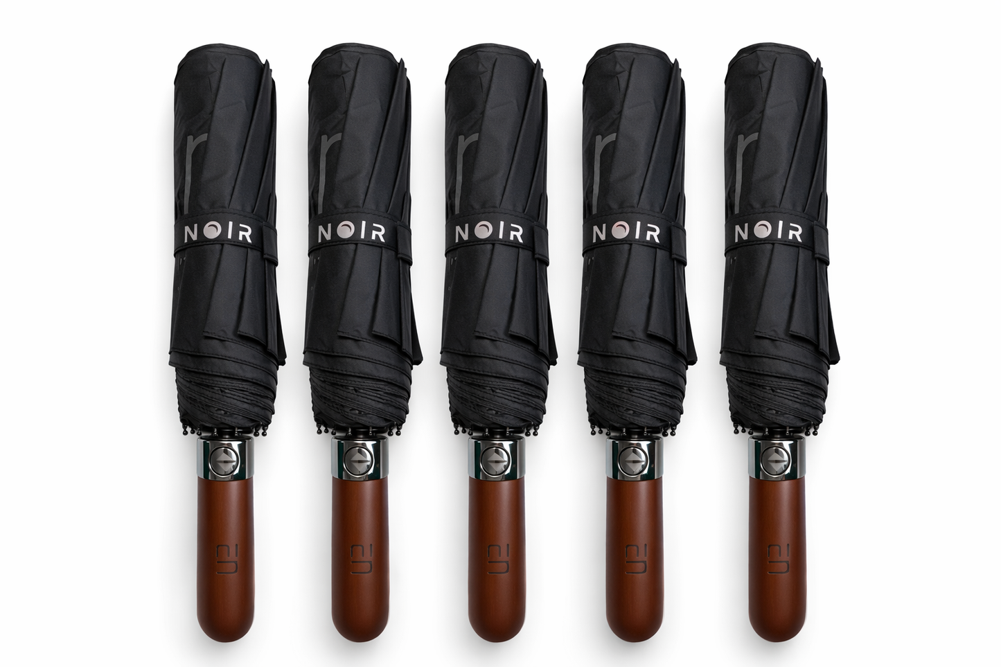 Five black umbrellas with brown wooden handles labeled 'ELEGANT NOIR' on a white background